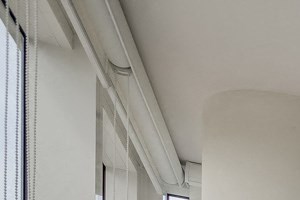 Dramatic Elevated Ceilings a living room with a white couch and a table